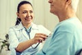 Beaming female doctor listening to heart beating Royalty Free Stock Photo