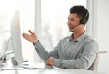 Everything seems to be in order. a young male call center agent using a computer in an office at work. Royalty Free Stock Photo