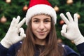 Everything will be fine for christmas. Close up Portrait of woman wearing a santa claus hat with emotion. Against the background Royalty Free Stock Photo