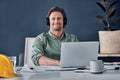 Everything is working in my favor today. Portrait of a handsome young architect wearing headphones while working in his Royalty Free Stock Photo