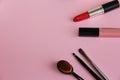 makeup brushes and lipstick on a pink background Royalty Free Stock Photo
