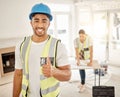 Everythings all going to plan over here. a handsome young construction worker standing inside and making a thumbs up