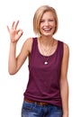 Everythings going to be allright. Studio portrait of a smiling young woman giving the ok sign to the camera isolated on