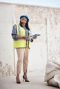 Everythings on schedule. Full length shot of an attractive young female construction worker working on site. Royalty Free Stock Photo