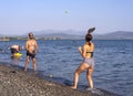 Evia Island, Greece. July 2019: Boy and girl playing frescobol on the beach - beach tennis - wooden rackets and ball on a Sunny su