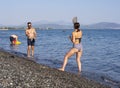 Evia Island, Greece. July 2019: Boy and girl playing frescobol on the beach - beach tennis - wooden rackets and ball on a Sunny su