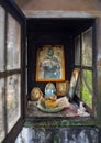 Evia Island, Greece. November 2020: Candelakia - traditional miniature Church by the road in the forest with a burning candle and