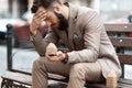 Evicted from home. A young homeless man sits outdoors in despair. Foreclosure notice Royalty Free Stock Photo