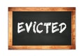 EVICTED text written on wooden frame school blackboard