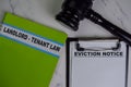 Eviction Notice on Document and Book Landlord-Tenant Law isolated on Wooden Table