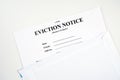 Eviction notice, notice to quit document form in envelope isolated on white.
