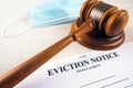 Eviction notice, notice to quit document with facial mask and gavel Royalty Free Stock Photo