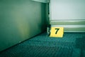 Evidence marker number 7 on carpet floor near suspect object in Royalty Free Stock Photo