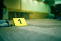 Evidence marker number 7 on carpet floor near suspect object in Royalty Free Stock Photo