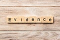 Evidence word written on wood block. evidence text on table, concept