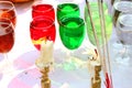 Evil candles burning and color water in glasses background