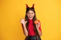 evil child in imp horns. happy halloween. devil kid with pumpkin. trick or treat. Royalty Free Stock Photo