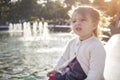 Evil expression face. Portrait of little angry toddler girl she grimaces and shows a grin Royalty Free Stock Photo