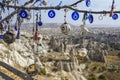 Evil Eye Beads on Tree and Fairy tale chimneys on background of blue sky in Pigeons Valley,Goreme