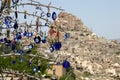 Evil eye in tree behind Uchisar Castle in Cappadocia Royalty Free Stock Photo