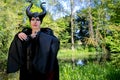 Evil fairy tale, maleficent, malevolent queen with horns and crow feather gown