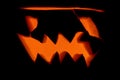 Evil glowing burning pumpkin jack lantern for Halloween on a black background Royalty Free Stock Photo