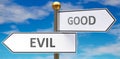 Evil and good as different choices in life - pictured as words Evil, good on road signs pointing at opposite ways to show that Royalty Free Stock Photo