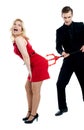 Evil guy poking sensual woman in red Royalty Free Stock Photo