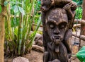 Evil looking african carved wooden sculpture, traditional garden decorations