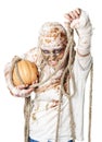 Evil mummy is holding pumpkin