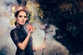 Evil Queen with Poisoned Apple in Misty Forest Royalty Free Stock Photo