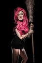 Evil red-haired witch and her broomstick Royalty Free Stock Photo