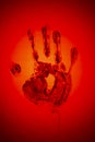 Evil red human palm imprint on red backdrop as sign of danger and warning Royalty Free Stock Photo