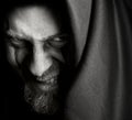 Evil sinister man with malefic wicked grin Royalty Free Stock Photo