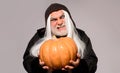 Evil wizard with orange pumpkin. Fantasy horror Halloween. Wicked Devil man with Jack-o-lantern. Angry Demon on