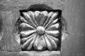 Black and white image of flower shaped inlay of old exterior wooden door