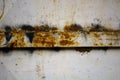 Detail close-up of white iron door with rusty parts