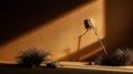 A lone microphone on a stand rests against a textured ochre wall bathed in sunlight, casting dramatic shadows; desert Royalty Free Stock Photo