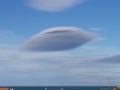 Lens shaped cloud with the sea in the distance