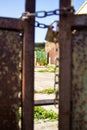 Part of rusty gate with chain and lock