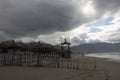 Sandy beach with rough sea and clouds Royalty Free Stock Photo