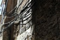 Water pipes and electricity wires positioned on the facade of an ancient building