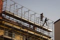 Workers engaged in assembling a scaffolding
