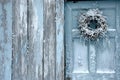 Old white wooden door with a wreath of ivy on it Royalty Free Stock Photo