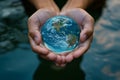 An evocative and symbolic World Water Day, featuring hands cupping clear, clean water with a reflection of the Earth, emphasizing