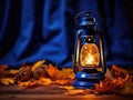 Autumn's Beacon: Vintage Lantern Casting a Warm Glow Among Maple Leaves on a Cobalt Canvas