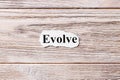 EVOLVE of the word on paper. concept. Words of EVOLVE on a wooden background Royalty Free Stock Photo