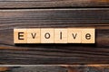 EVOLVE word written on wood block. EVOLVE text on wooden table for your desing, concept Royalty Free Stock Photo