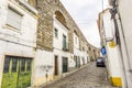 Evora street with traditional houses built in ancient roman aqueduct, Portugal Royalty Free Stock Photo