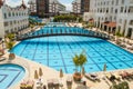 Huge empty pool with blue transparent water on the territory of a resort hotel